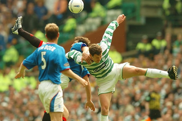 Celtic goal scorer Chris Sutton in a mid air tangle with Rangers Zurab Khizanishvili in 2004.