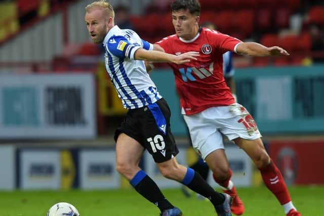Sheffield Wednesday captain Barry Bannan looks to wriggle away from Charlton's Albie Morgan.
