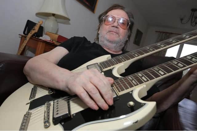 Frank White with his famous 1964 white twin neck Gibson guitar - the first of its model to be shipped from the States. Picture: Chris Etchells.jpg
