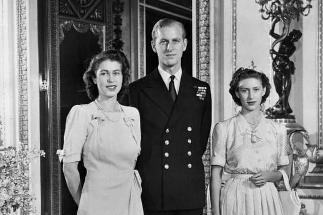 Princess Elizabeth (future Queen Elizabeth II), Philip Mountbatten (also the Duke of Edinburgh) and Princess Margaret pose in the Buckingham Palace on July 09, 1947 in London, the day their engagement was officially announced.