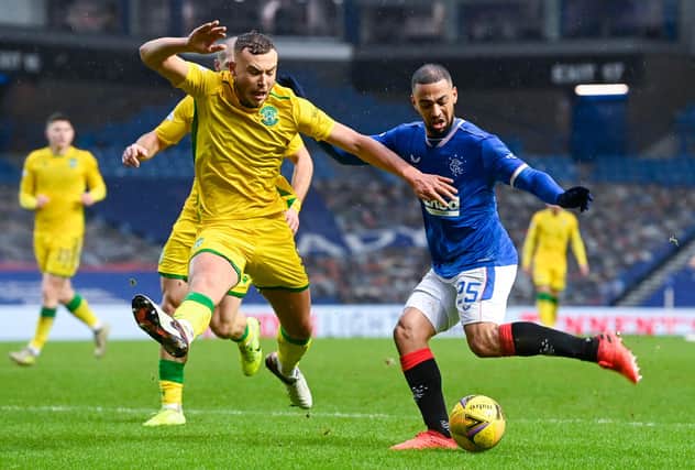 Ryan Porteous attempts to block Kemar Roofe's path to goal at Ibrox as Rangers take on Hibs