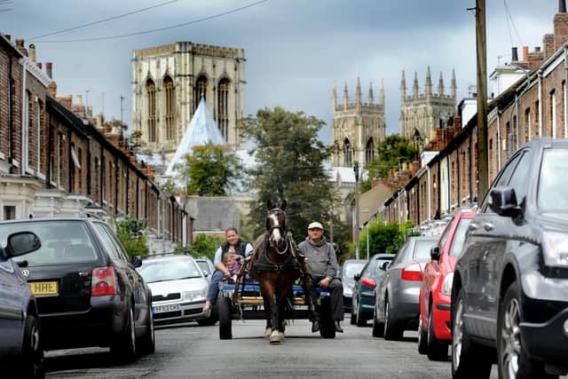 Date:12th September 2011.
Possible Picture Post>>>>>>
A Rag and Bone Man, Andrew Smith, 35, carefully drives Molly along St John's Street, York, passing parked cars whilst Violet Wilson, 31, and her daughter Deanna Wilson, 4, rests on the carriage with a back drop of York Minister.
Camera Details: Nikon D3s, Nikon VR 70-200mm, Aperture F6.3, Shutter Speed 1/250's, ISO 400.