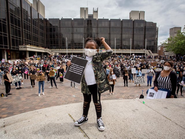 Four-year-old Nala-Paris Mbah makes a powerful statement in front of the crowds at yesterday's protest.
