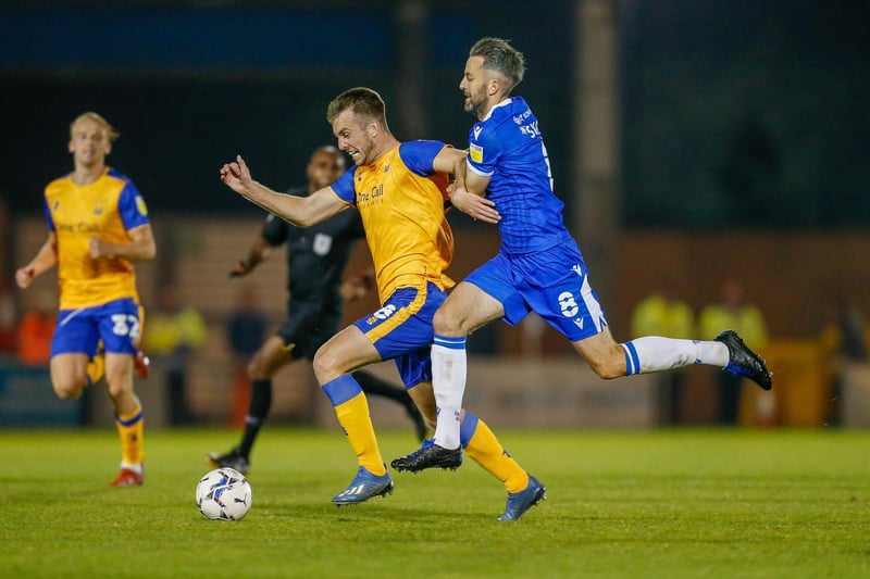 Rhys Oates is held back by Colchester's Cole Skuse