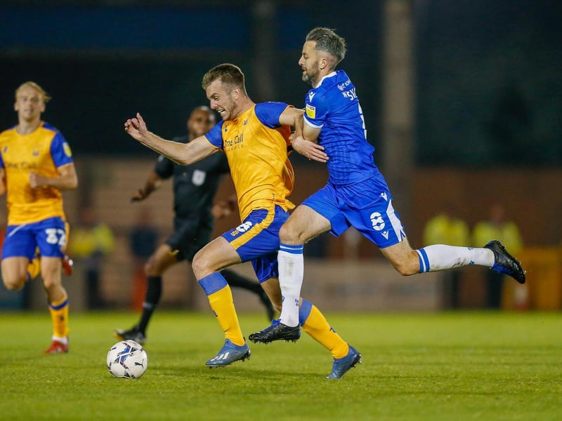 Rhys Oates is held back by Colchester's Cole Skuse