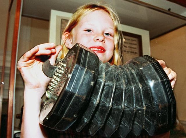 Nine year-old Ellie May Holland back in 1997. Holding an Concertina - part of the museum's exhibition.