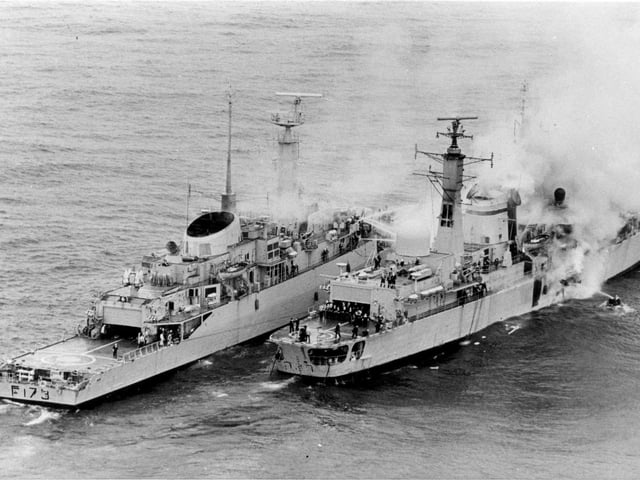 HMS Sheffield 28 May 1982. Twenty lives were lost in a strike by an exocet missile. A type 21 frigate helps to put out fire on Sheffield, however she sank soon after.