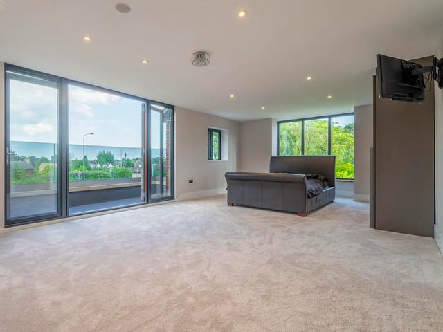 The master bedroom offers a huge amount of space. Not to mention a balcony.