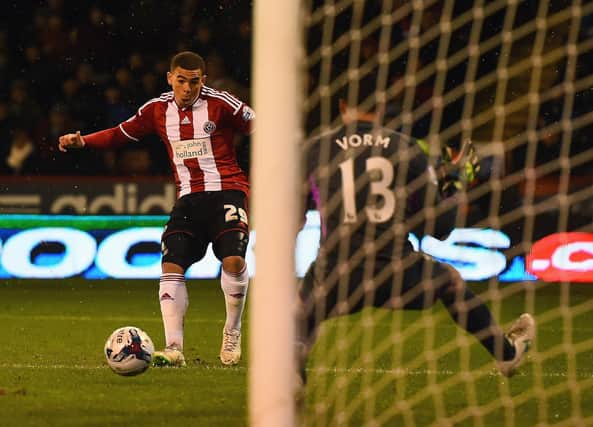 Che Adams scores his first goal against Spurs in the 2015 League Cup semi-final  (Photo by Laurence Griffiths/Getty Images)