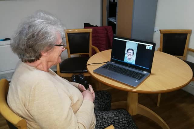 A resident at Norton Lees Hall and Lodge Care Home using the Skype facility to chat with her daughter
