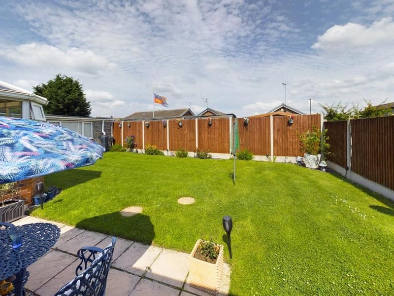 Rear garden - Fence enclosed, laid to lawn with raised flower beds, paved path and patio area. External lighting and garden tap.