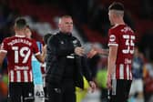 Wayne Rooney, manager of Derby County, congratulates Sheffield United's Kacper Lopata on his performance against his team in the Carabao Cup: Alistair Langham / Sportimage