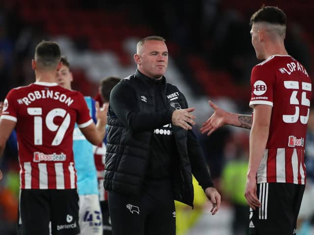 Wayne Rooney, manager of Derby County, congratulates Sheffield United's Kacper Lopata on his performance against his team in the Carabao Cup: Alistair Langham / Sportimage