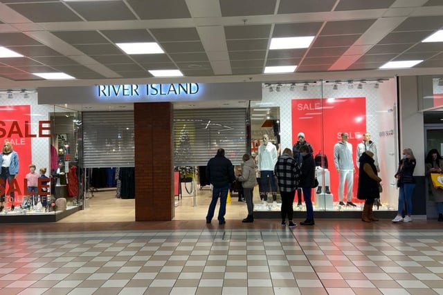 Shoppers wait to go inside River Island as the store opens on Boxing Day.