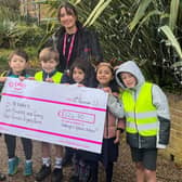 Ellie Matthews receives a cheque from the Dobcroft children