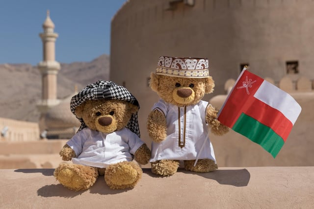 John James and bob the teddy bears in native clothes in Muscat, Oman. 
These adorable teddy bears could be the world's most well-travelled cuddly toys - as their photographer owner has chronicled their adventures in 27 different countries. Christian Kneidinger, 57, has been travelling with his teddy bears, named John and Bob since 2014 - and his taken them to some of the world's most famous landmarks. The teddy bears have dressed up in traditional Emirati clothing to visit the Sultan's Palace in Oman, and have braved the cold on a glacier on Lofoten Island in Norway.
