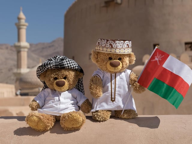 John James and bob the teddy bears in native clothes in Muscat, Oman. 
These adorable teddy bears could be the world's most well-travelled cuddly toys - as their photographer owner has chronicled their adventures in 27 different countries. Christian Kneidinger, 57, has been travelling with his teddy bears, named John and Bob since 2014 - and his taken them to some of the world's most famous landmarks. The teddy bears have dressed up in traditional Emirati clothing to visit the Sultan's Palace in Oman, and have braved the cold on a glacier on Lofoten Island in Norway.