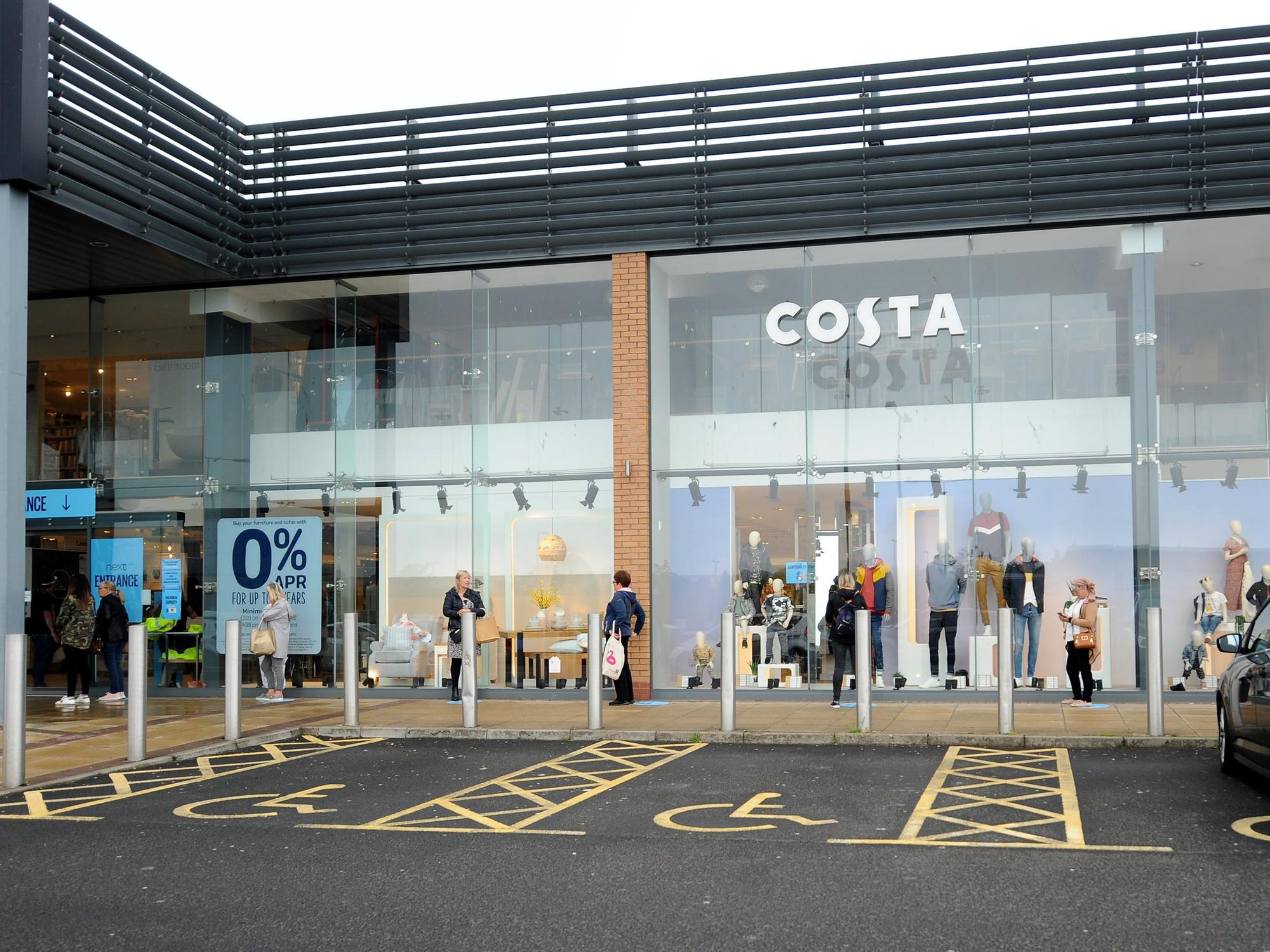 Socially distanced queuing outside Next as it reopened.