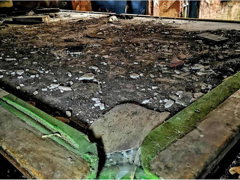 Remants of green baize remain amongst the rubble.