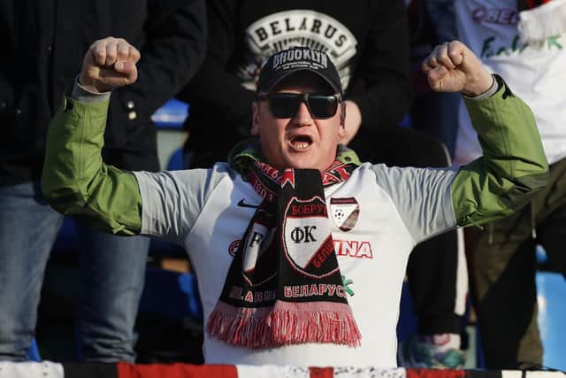 A fan of Belshina Bobruisk team cheers during the Belarus Championship soccer match between Torpedo-BelAZ Zhodino and Belshina Bobruisk in the town of Zhodino, Belarus: AP Photo/Sergei Grits