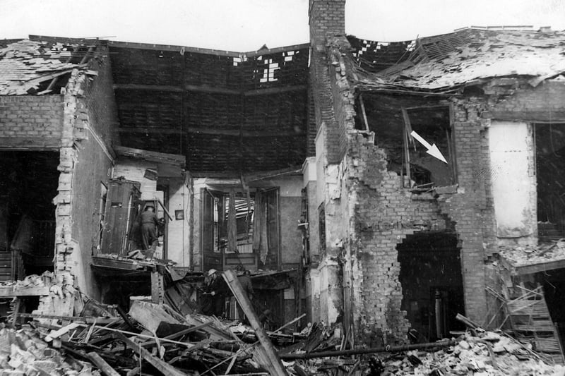 A child was rescued from this wreckage in Tunstall Vale, 10 hours after a German air raid. The arrow indicates the corner of the bedroom in which the baby was found.