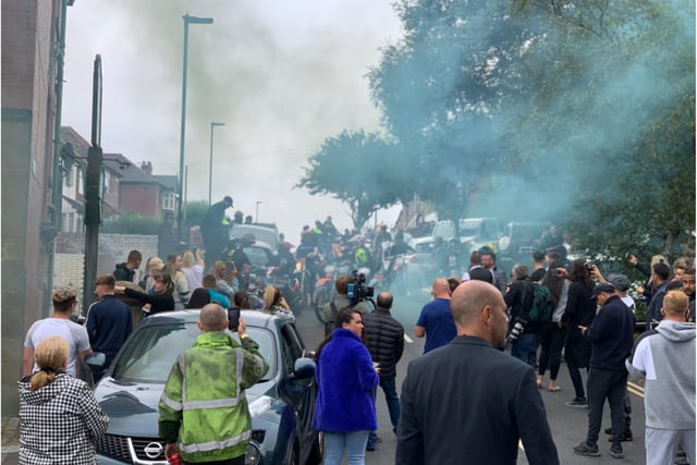 Smoke bombs were let off by mourners.
