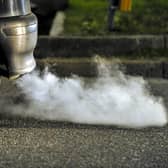 Car belching out exhaust fumes. Sheffield Council's Clean Air Zone won't be in place until 2023 'at the earliest'