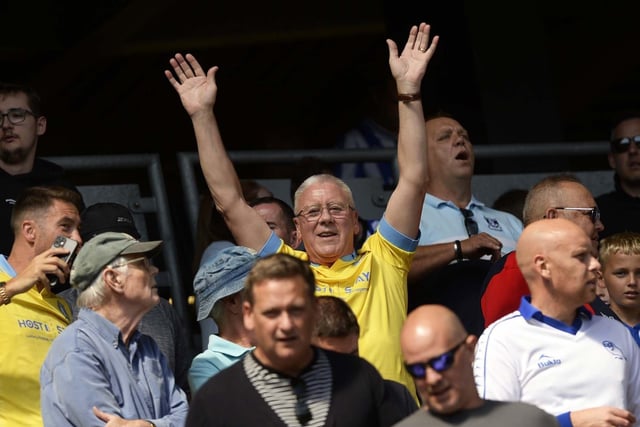 Some of the 6,500 fans enjoying a win in the sun at Milton Keynes .   Pic Steve Ellis