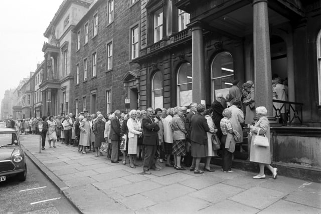 Edinburgh pensioners queue outside the office in Queen Street Edinburgh to apply for the special OAP's bus ticket from Lothian Region in August 1983.