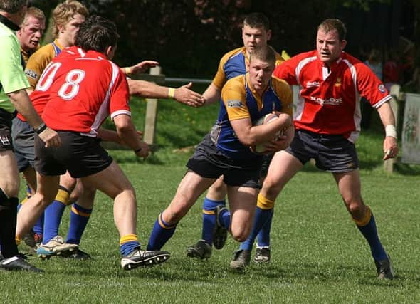 Matlock's Adam Twyford, with ball, in action against Ashbourne at Derby RFC in the 2009 county cup final.