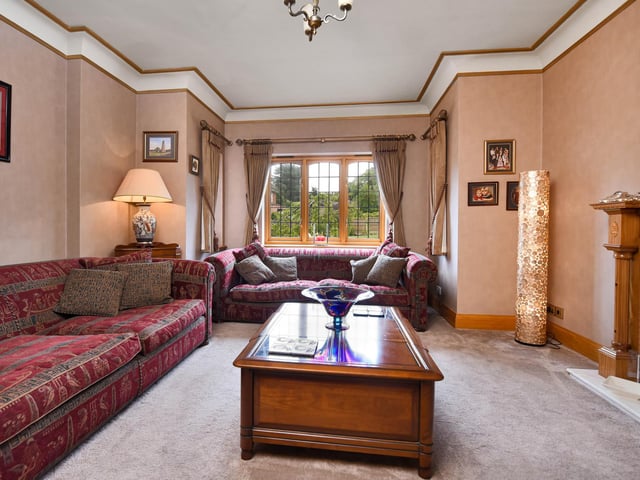 The snug has a fireplace and a bay window.