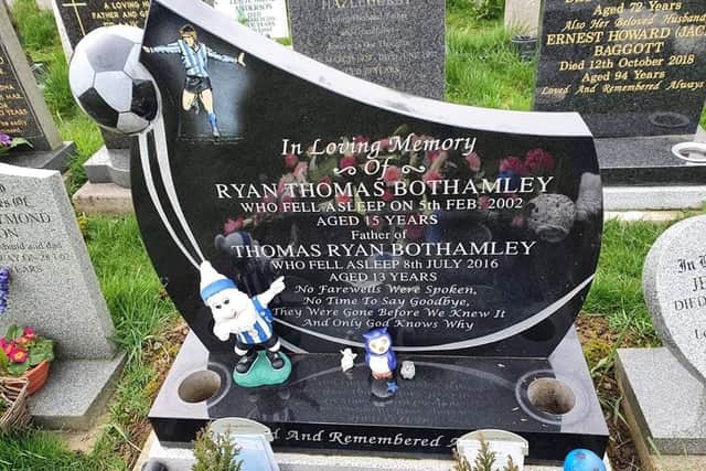 Ryan and Tom Bothamley's grave after thieves stole silver flower pots and an owl statuette from the resting place of the Sheffield Wednesday superfans
