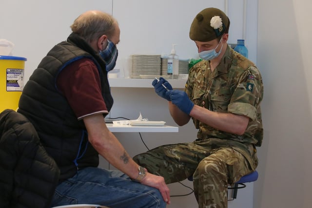 Derek Fraser from Edinburgh receives his coronavirus vaccine from military doctor Captain Robert Reid from 3 Medical Regiment.