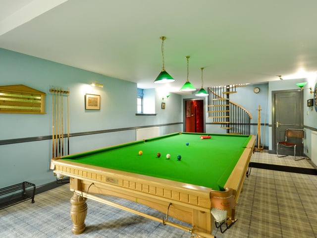 The original part of the steading now houses a games room, with a spiral staircase leading up to a one-bedroom studio apartment