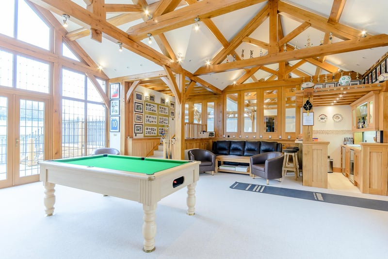 This fantastic games room also has a built-in bar and seating area