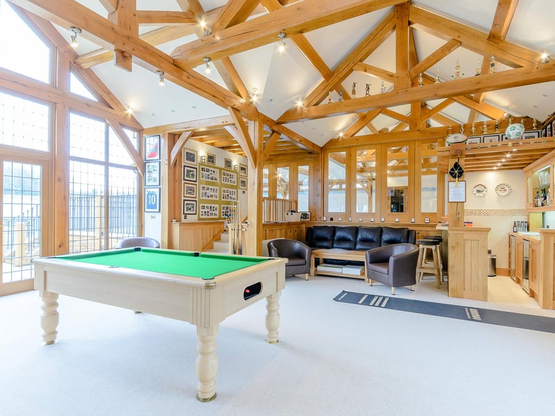 This fantastic games room also has a built-in bar and seating area