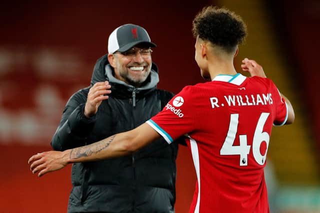 Liverpool's German manager Jurgen Klopp (L) celebrates with Liverpool's English defender Rhys Williams (R) on the pitch after the English Premier League football match between Liverpool and Southampton at Anfield in May: PHIL NOBLE/POOL/AFP via Getty Images
