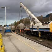 Work is continuing to re,move the derailed train