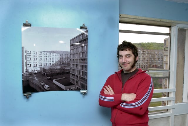 Eric Winnert with his photographs of Sheffield's Park Hill flats, in one of the flats