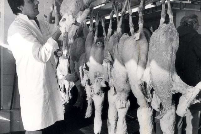 Tony Adam's manager of J.Armtstong Ltd, Totley, with Christmas geese and turkeys in his shop. December 22, 1982