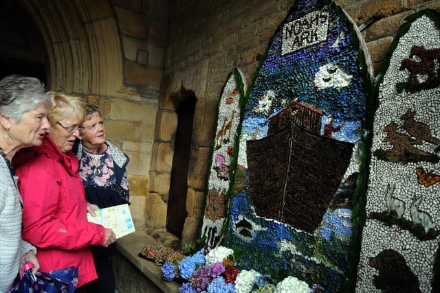 Visitors from Mersyside enjoy the well dressing creation during a trip to St. Mary's Church in Chesterfield in 2014