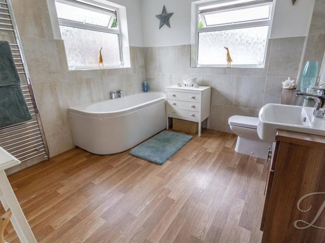 It's hard to fault the family bathroom. Pleasantly presented, it boasts a vanity unit, bath, double shower, low-flush WC and heated towel-rail.