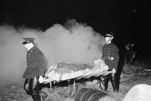 Firemen carry a stretcher during a mock air crash exercise at Turnhouse Airport in December 1963.