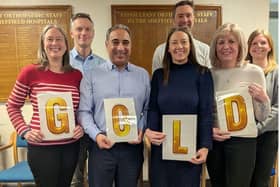 Mr Amjid Ali (third right) celebrates the team’s ‘Gold’ status recognition with members of the orthopaedic and theatre team.