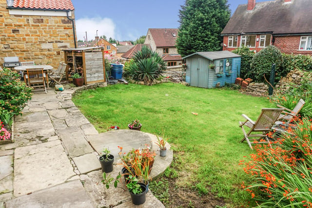 At the front of the house is a patio area, lawned garden and garden shed.