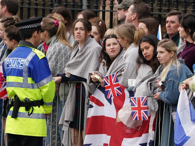 Background actors during filming for the next season of The Crown in St Andrews. Filming took place in the Fife town’s North Street, with scores of extras holding Union flags and Saltires in front of the historic St Salvator’s Chapel.