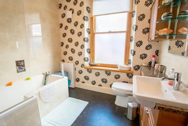 The house has two luxurious bathrooms (one ensuite) with elegant tiles.