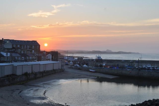 The sun sets at Seahouses Harbour.