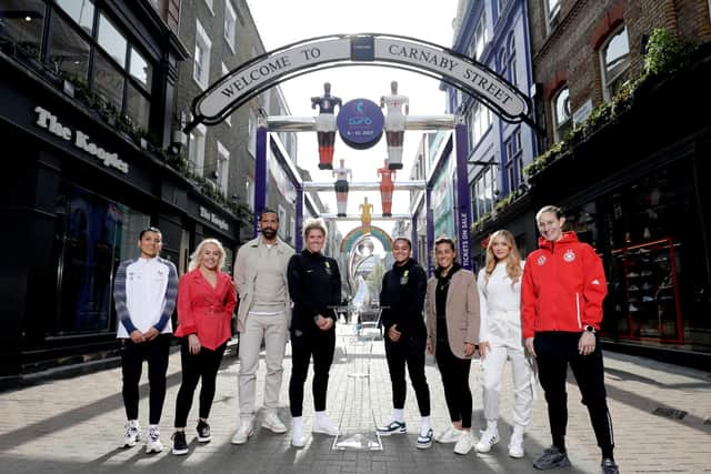 From left to right: Kenza Dali, Liv Cooke, Rio Ferdinand, Millie Bright, Jess Carter, Fara Williams, Elz the Witch and Ann-Katrin Berger unveil giant women’s table football players on London’s iconic Carnaby Street to mark tickets going on sale for UEFA Women’s EURO England 2022 on March 28, 2022 in London, England (photo by John Phillips/Handout via Getty Images).
