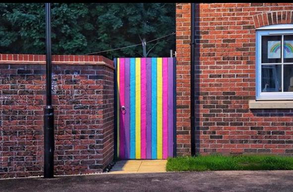 A very brightly painted gate photographed by @conorscamera